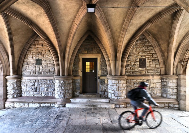Student riding a bike through the Eggleston Tunnel on Virginia Tech's campus